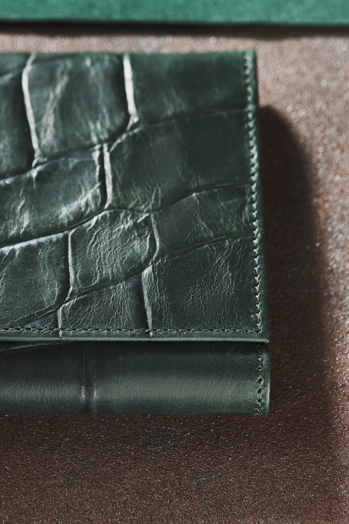 Close-up of Limited Edition Crocodylus matte emerald leather wallet